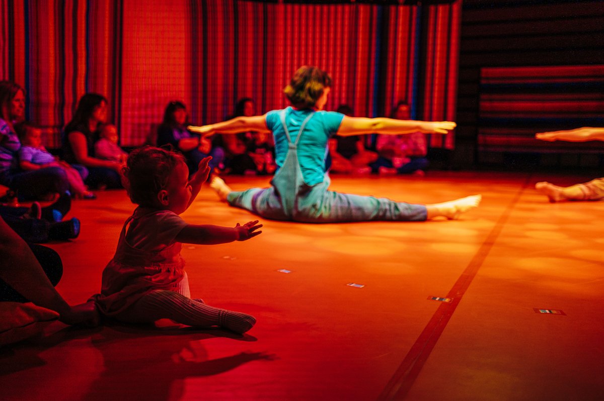 Young child mirroring performer during Little Top performance.